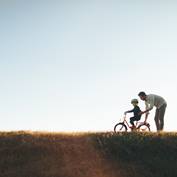 dad and son on bike