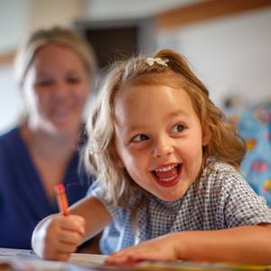 girl-drawing-with-nurse-in-background