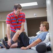 physical-therapist-working-with-young-man