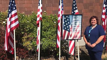 Amy Jensen with flags sized for caregiver news