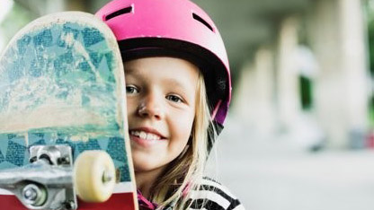 Girl in helmet with skateboard sized for sitecore