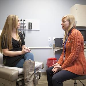 A doctor holds a discussion with one of her patients.