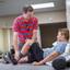 A physical therapist checks the leg or knee of his patient.