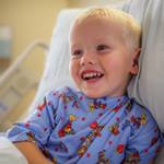 boy-in-hospital-bed-smiling