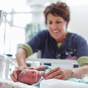 nurse-checks-on-infant-in-hospital-crib