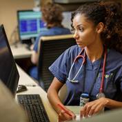 nurse-looking-at-computer-writing