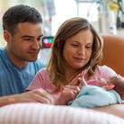 parents-hold-infant-in-nicu