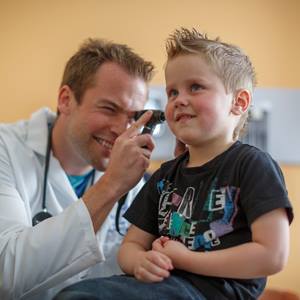physician-looking-into-boys-ear