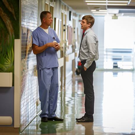 physician-office-worker-talking-in-hallway