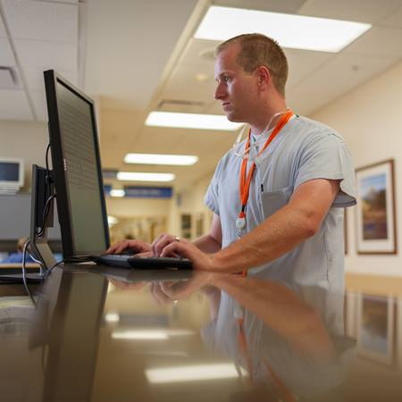male-nurse-at-computer-station