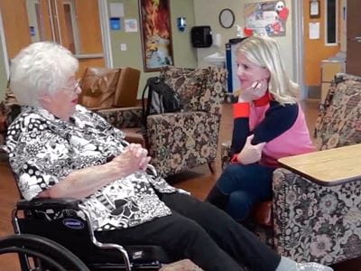 Elderly Female patient talks to younger female