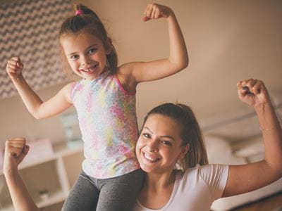 Mom and Daughter flex muscles