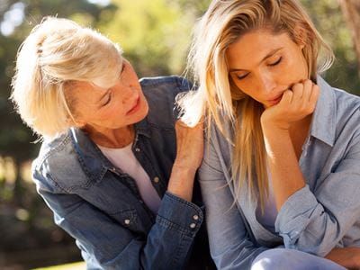 Woman comforts Middle age daughter