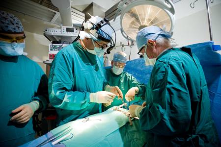 Surgeons perform a heart procedure on a patient