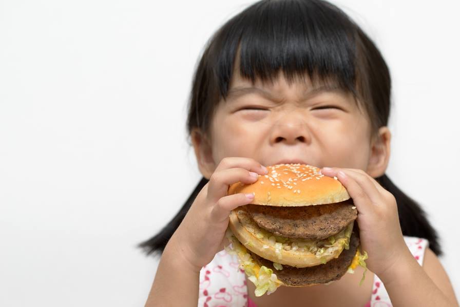 child eating burger