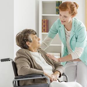 Femail-Caregiver-With-Elderly-Woman-In-Wheelchair