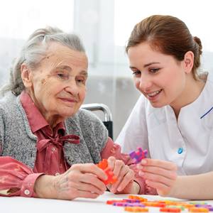 Nurse-Playing-Jigsa-With-Elderly-Woman