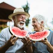 Happy couple eating watermelon