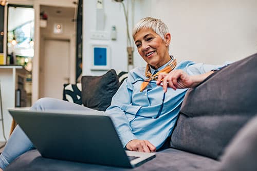 woman on couch with laptop