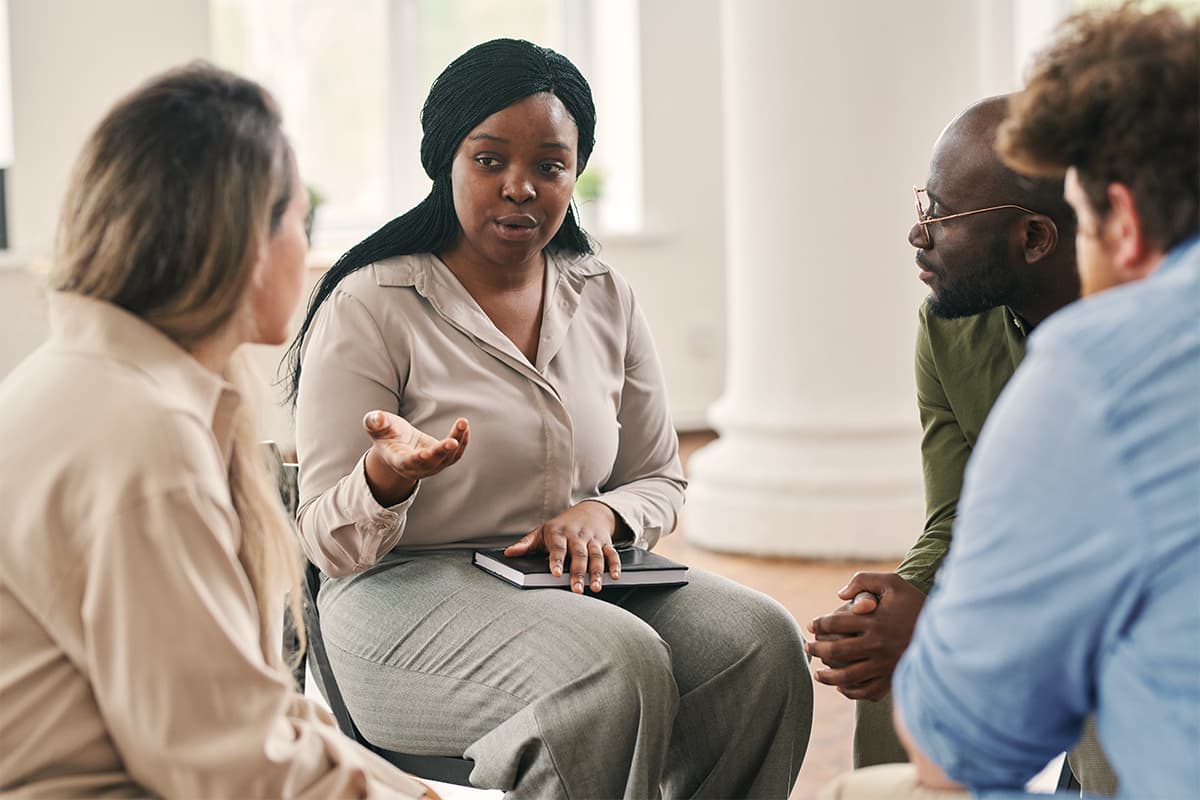Woman speaking in a group therapy session