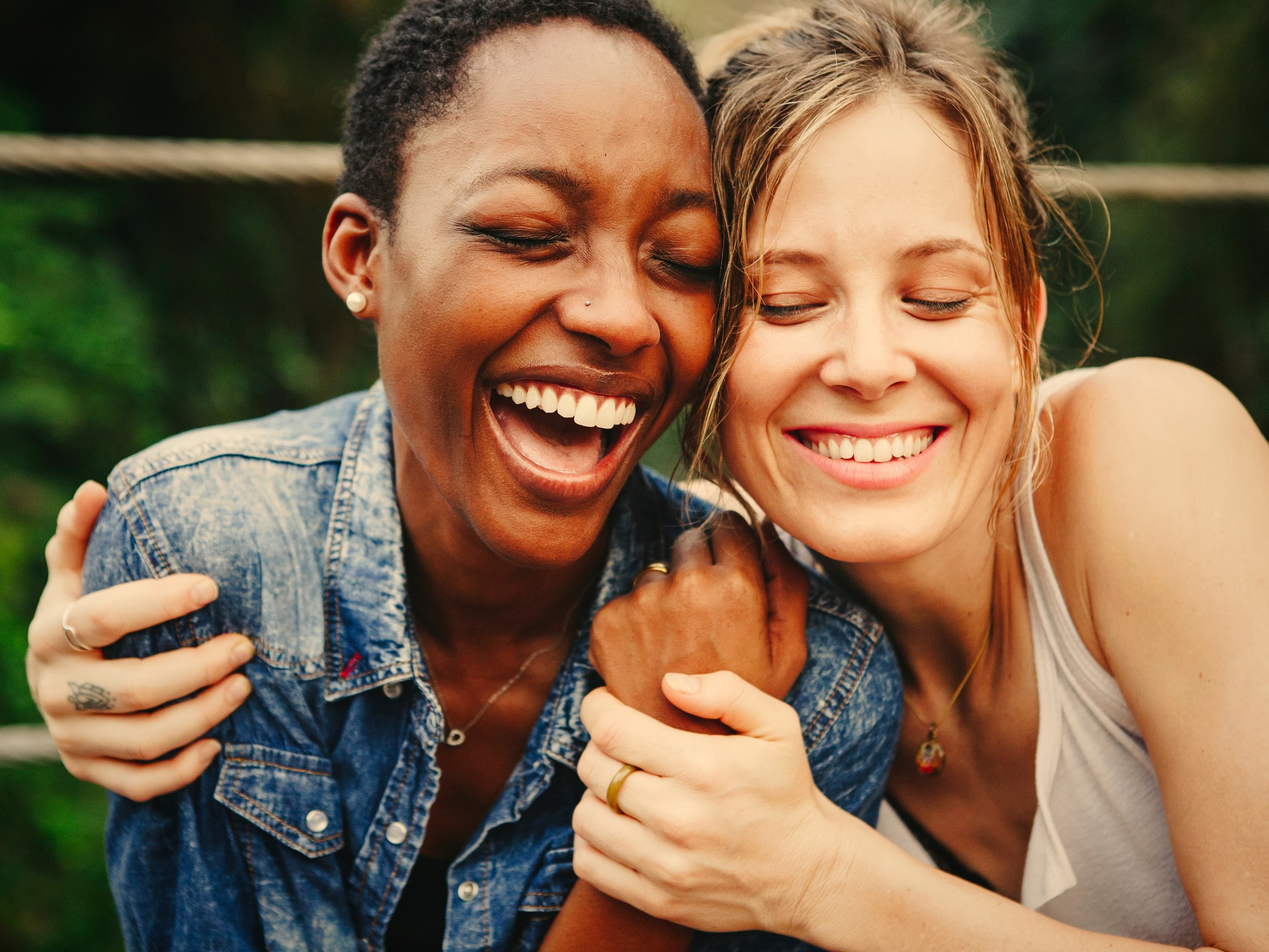 two women hugging and laughing