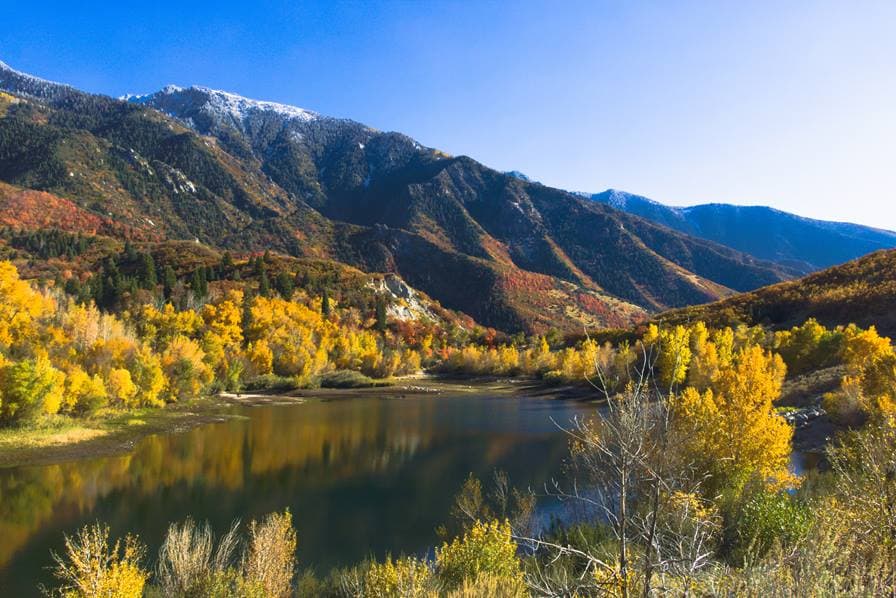 Mountains and lake in the fall with yellow leaves