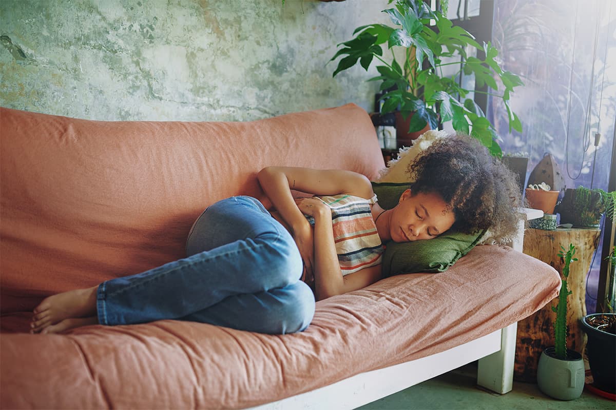 Young woman lying on a sofa sleeping