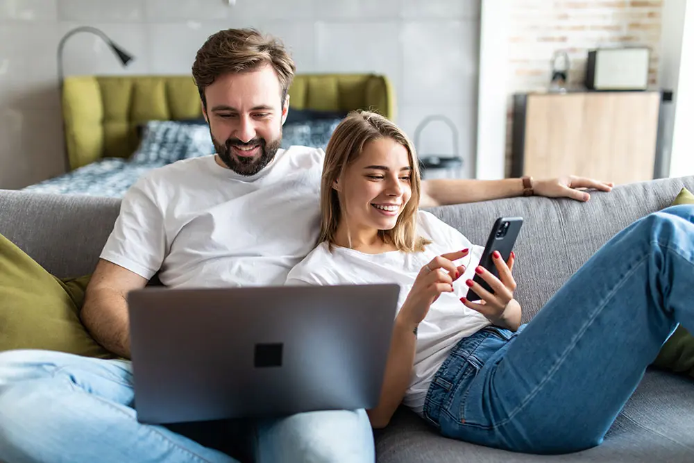 couple with phone and laptop