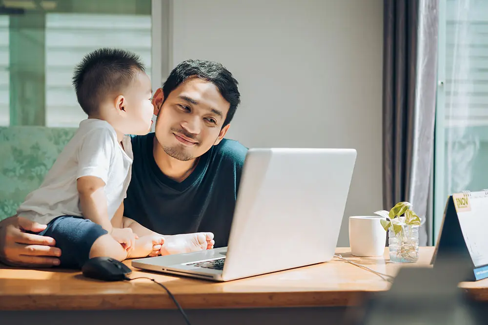 father and child on laptop